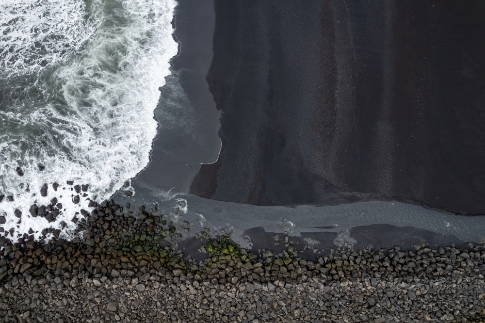 an aerial view of a black sand beach