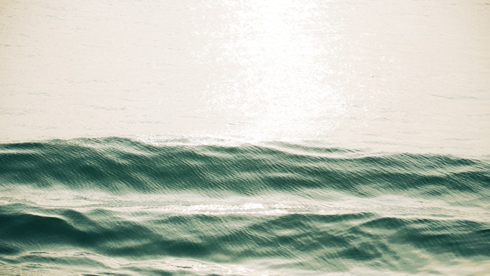 a person riding a surfboard on a wave in the ocean