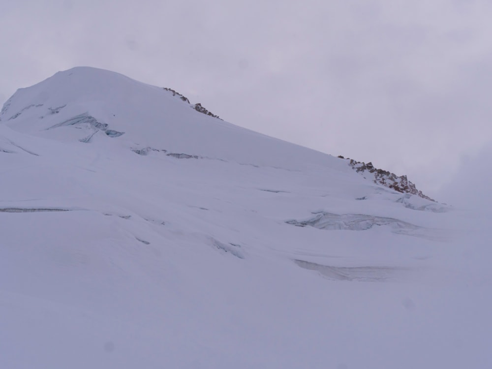 a man riding skis down a snow covered slope