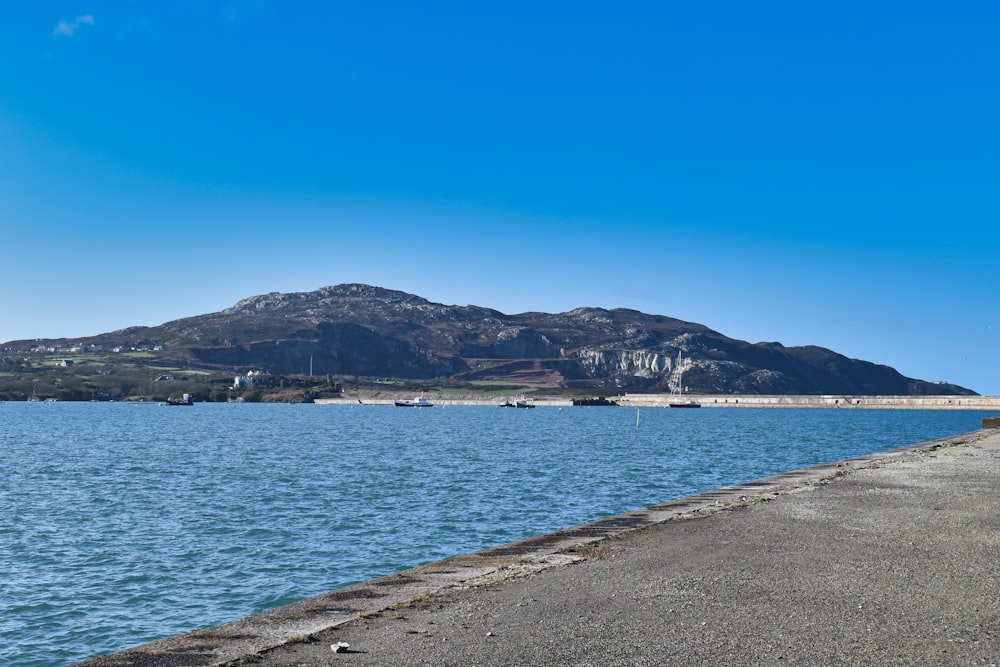 a view of a body of water with mountains in the background