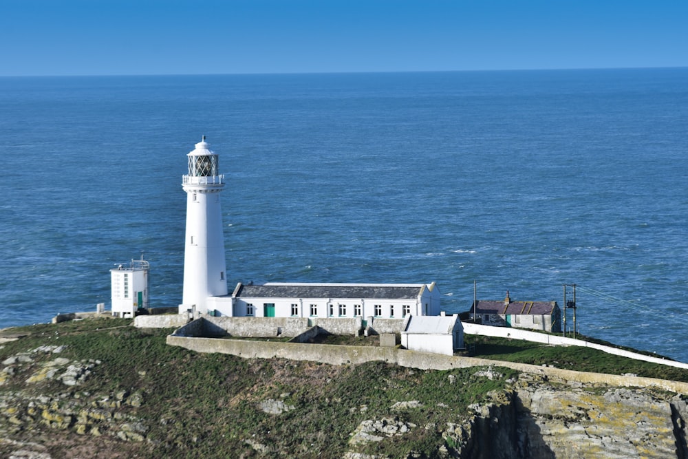 a lighthouse on a rocky cliff overlooking the ocean