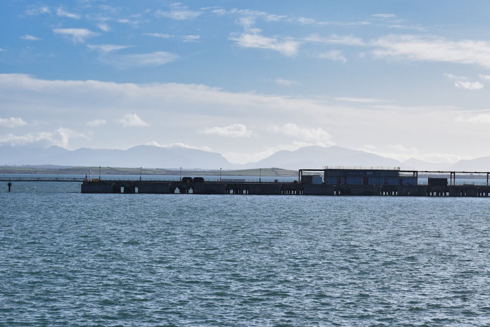 a large body of water with a bridge in the background