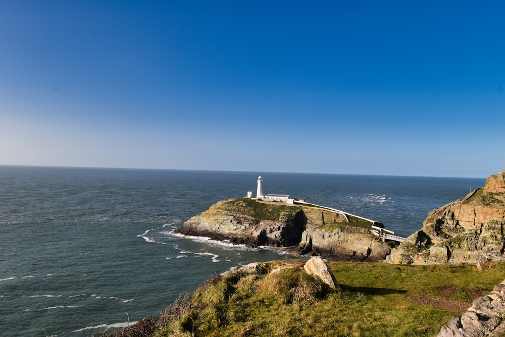 a lighthouse on a cliff overlooking the ocean