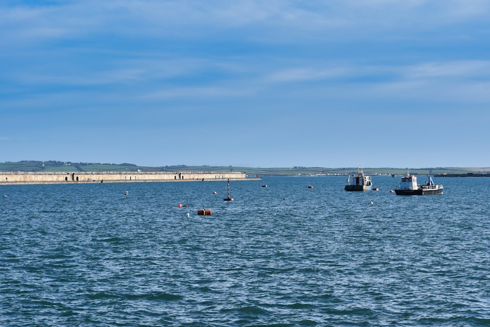 a group of boats floating on top of a large body of water