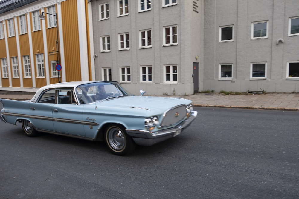 an old car is parked on the side of the road