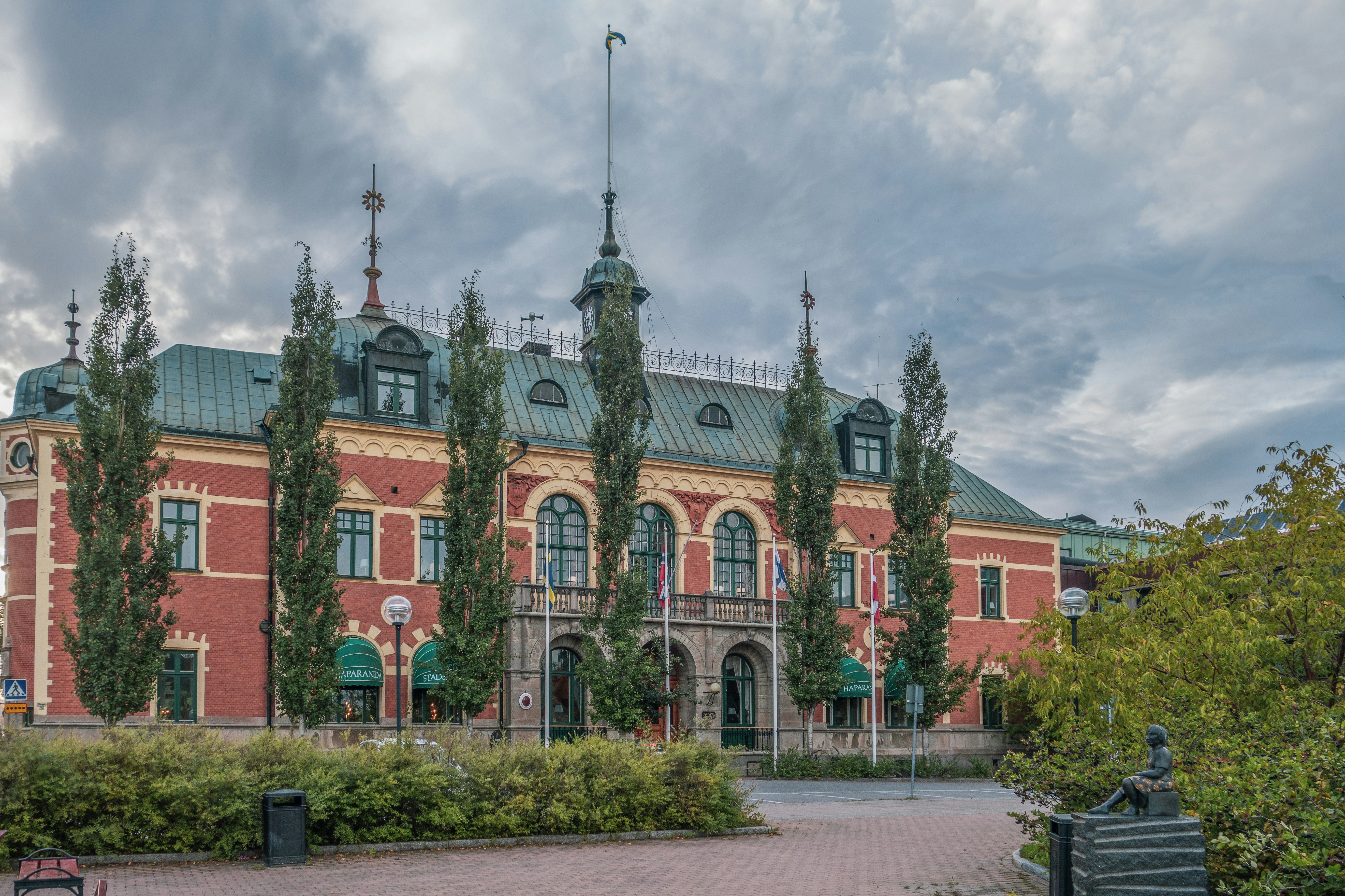 a large red brick building with a green roof