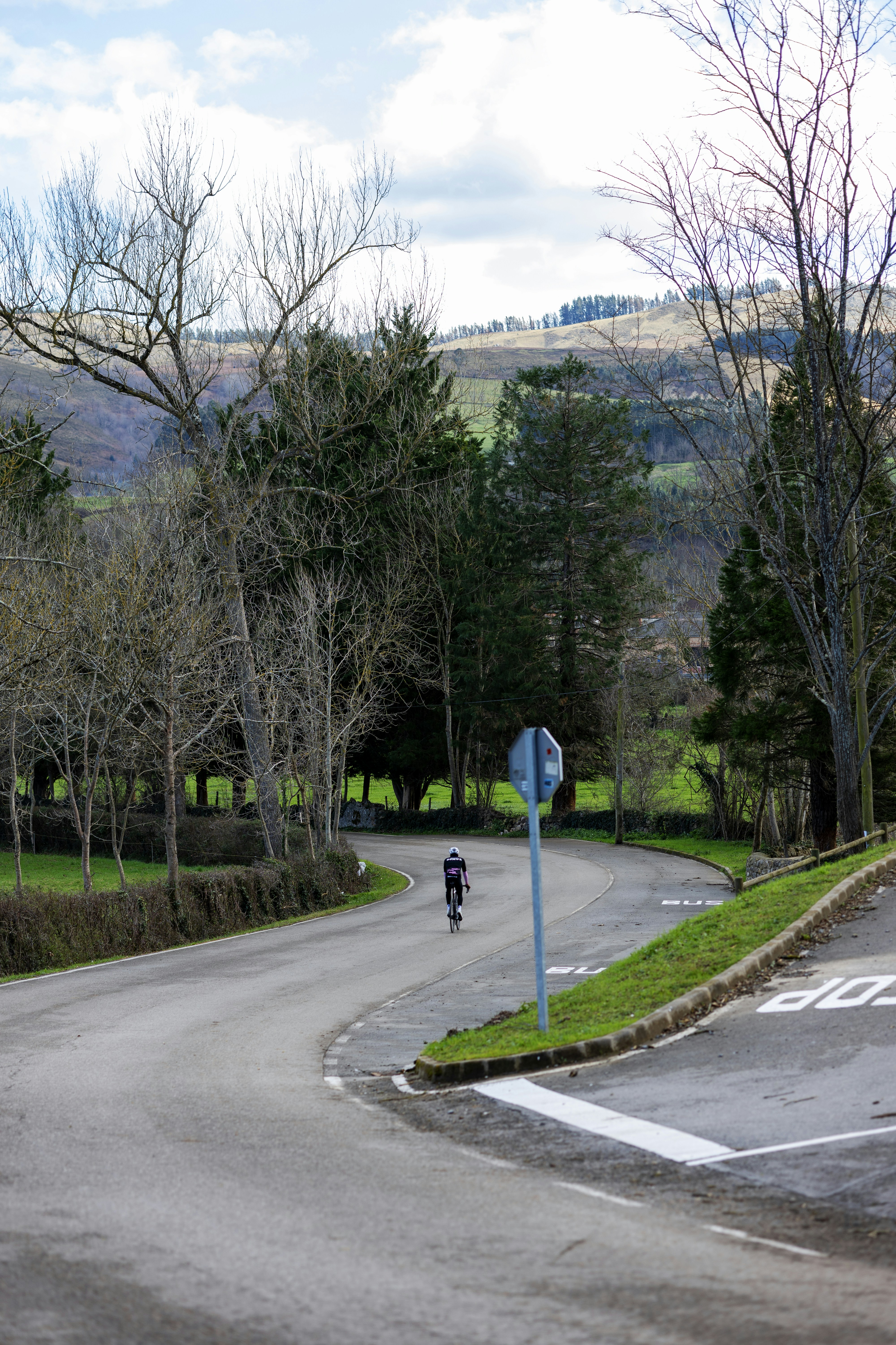 a man riding a bike down a curvy road
