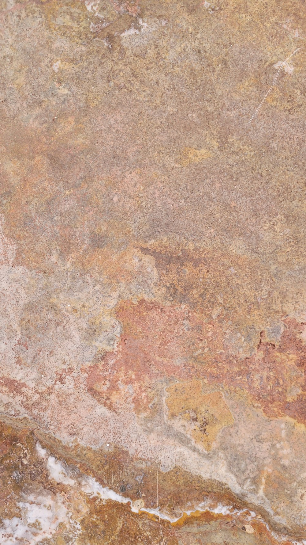 a close up of a stone wall with a clock on it