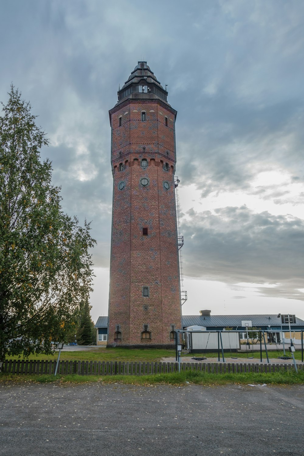 a tall brick tower with a clock on the top