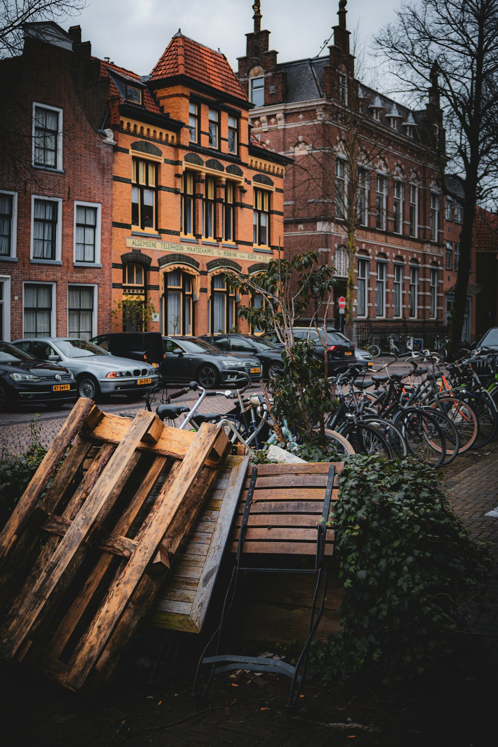 a pile of wood sitting in front of a tall building