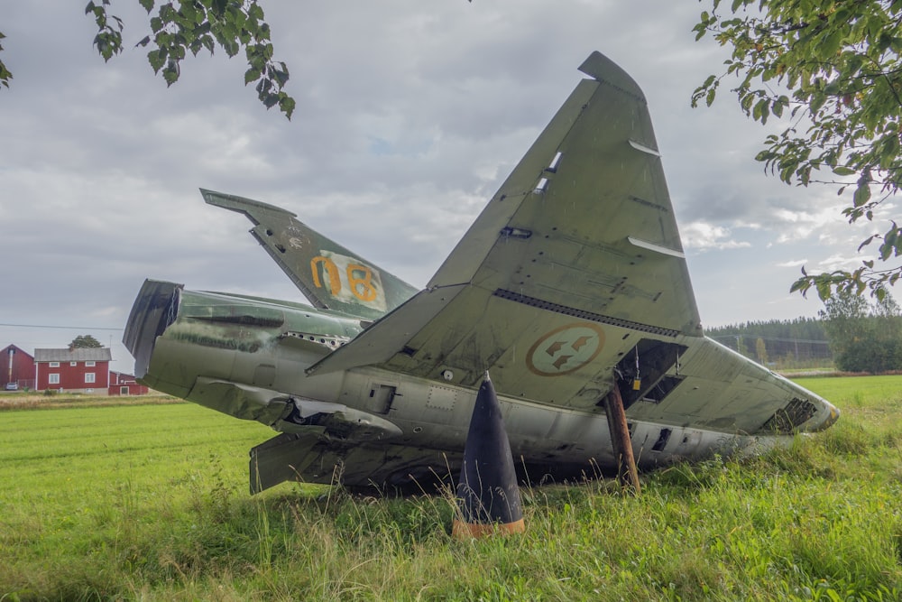 an old military plane sitting in a field
