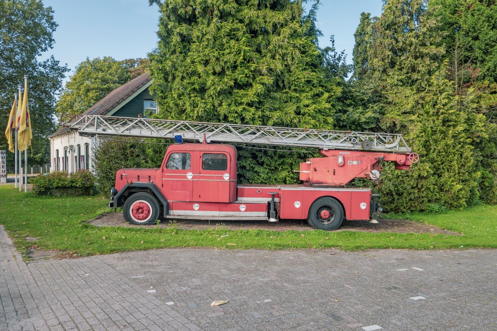 a red truck parked in front of a house