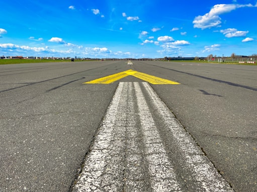 a yellow arrow painted on an empty runway