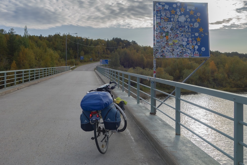 a bicycle parked on the side of a bridge