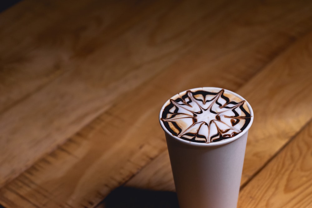 a coffee cup with a design on the top of it