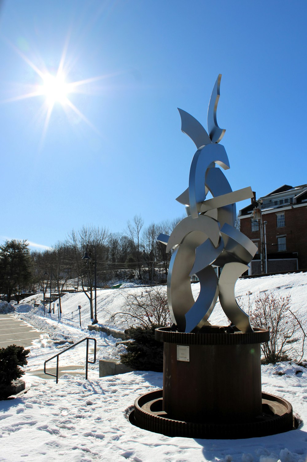 a statue of a fish on a pedestal in the snow