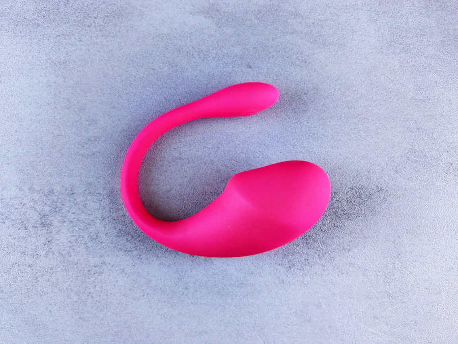 Pink egg-style massager on a pale surface