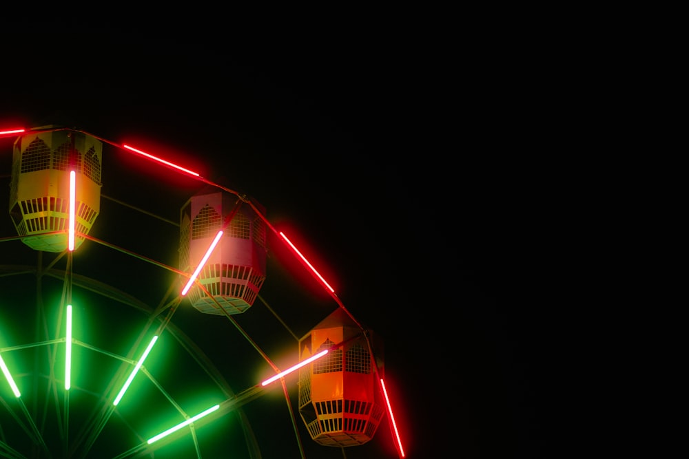 a ferris wheel lit up with red and green lights