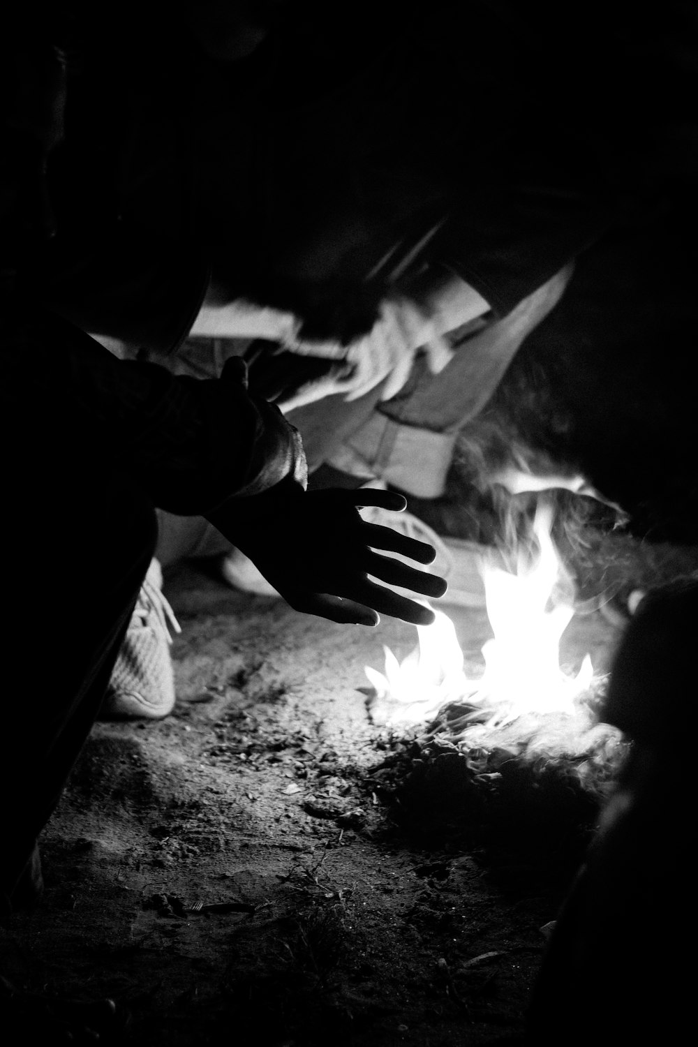 a black and white photo of a person reaching for something
