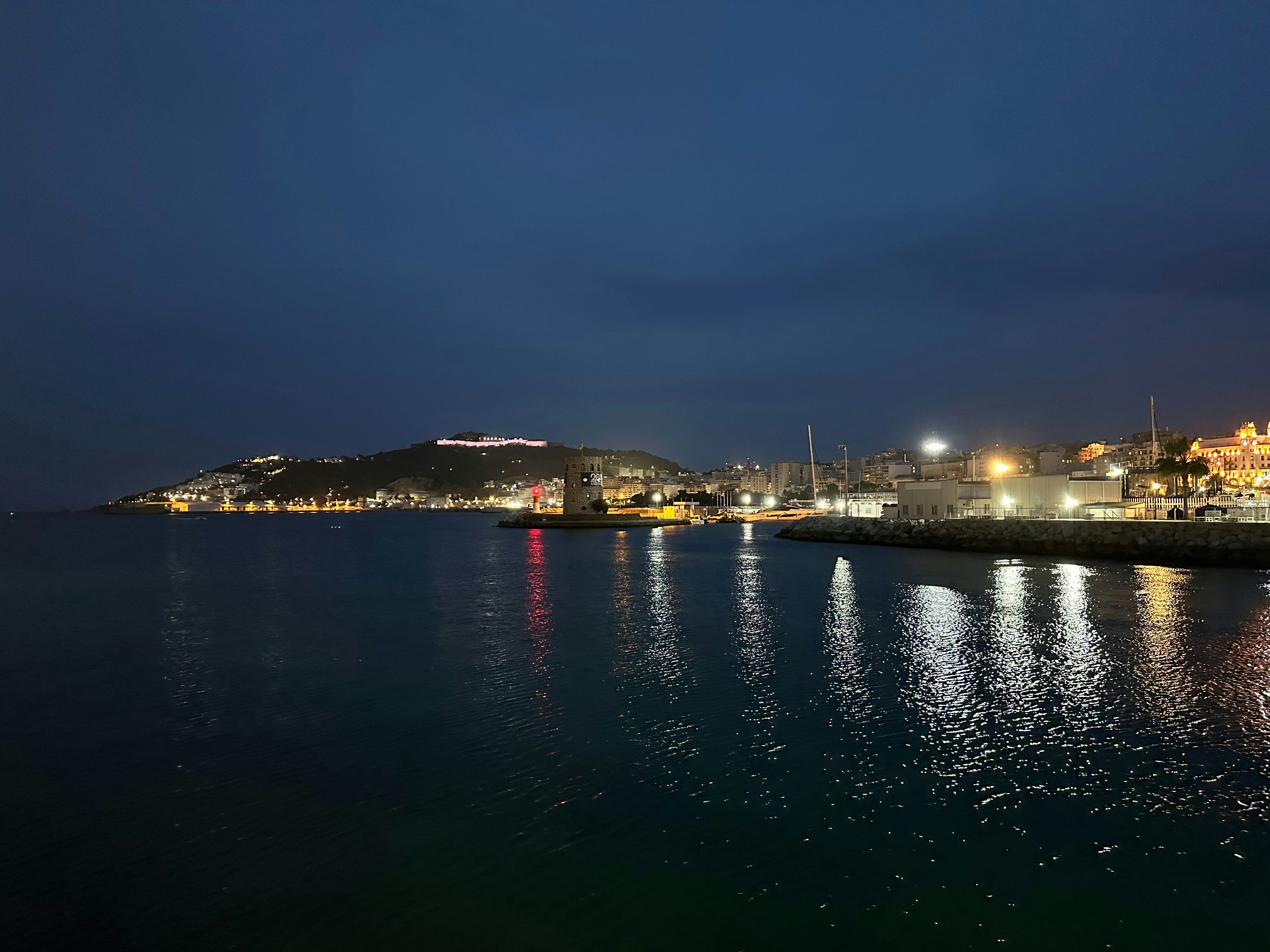 a body of water with a city in the background