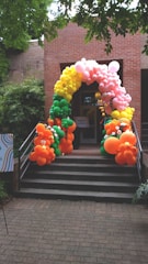 a bunch of balloons that are on some steps