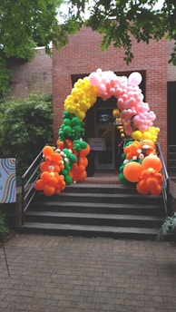 a bunch of balloons that are on some steps