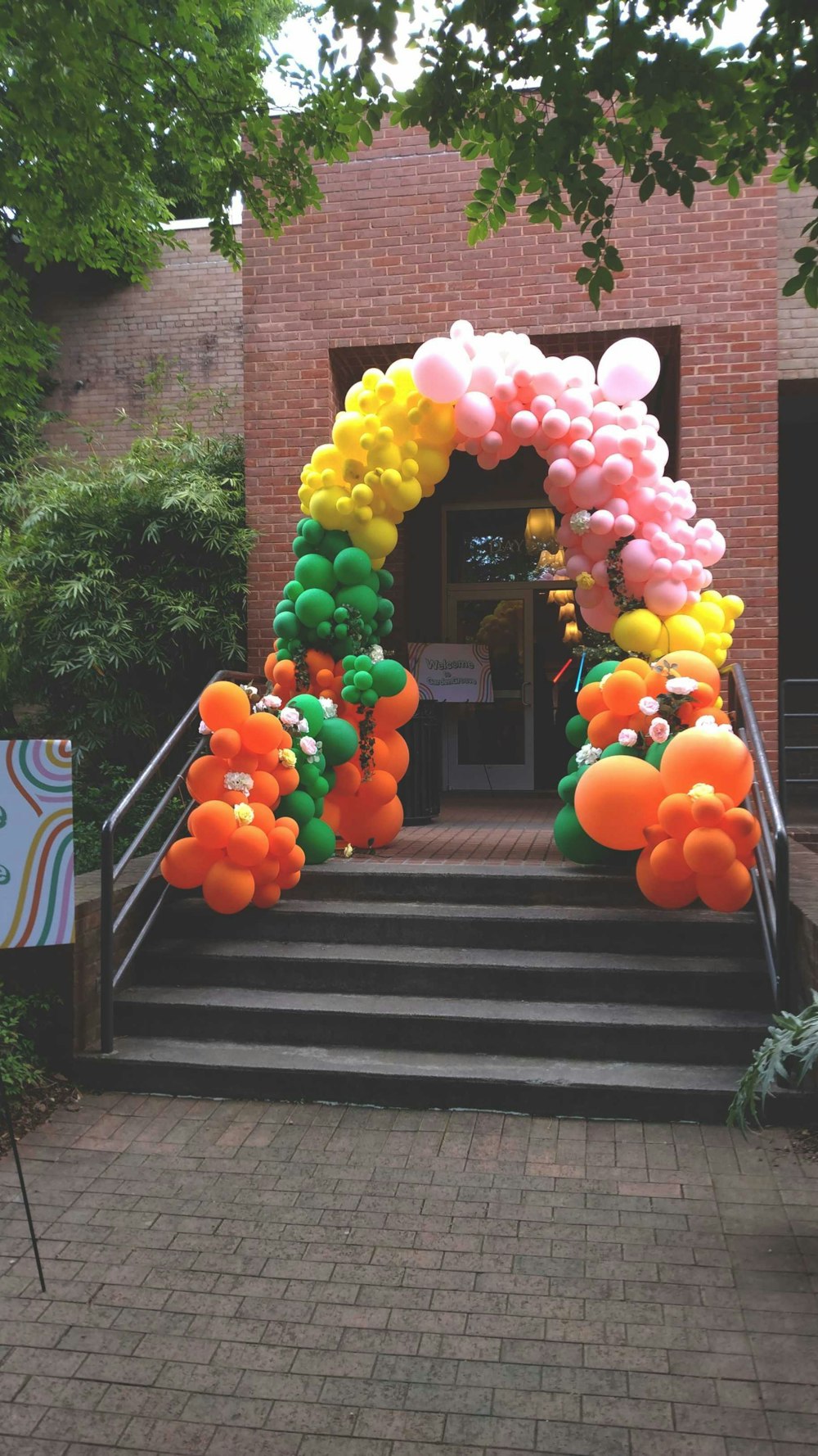 a bunch of balloons that are on some steps