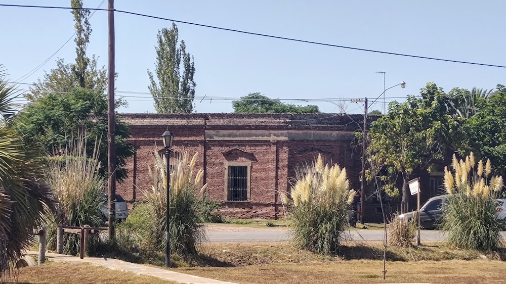 an old brick building with a car parked in front of it