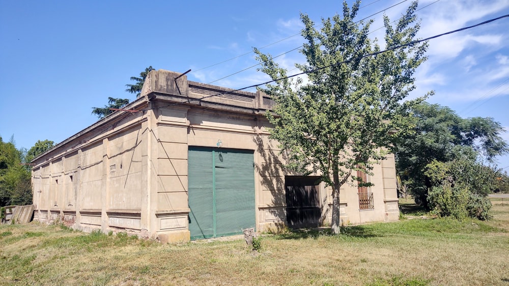 an old building with a tree in front of it