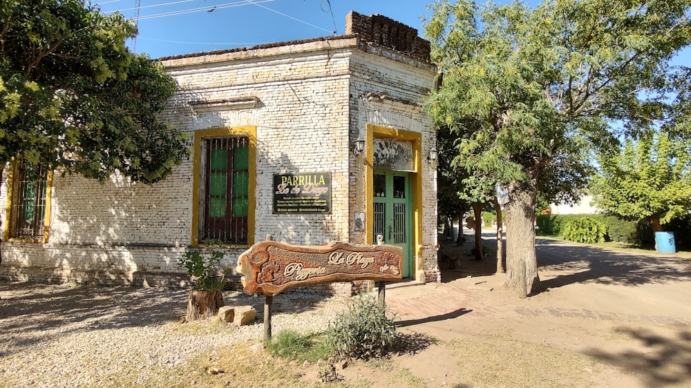 a brick building with a sign in front of it