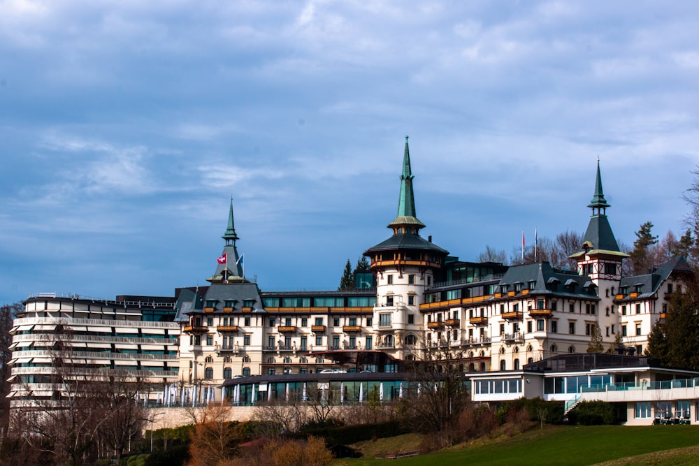 a large white building with green spires on top of it