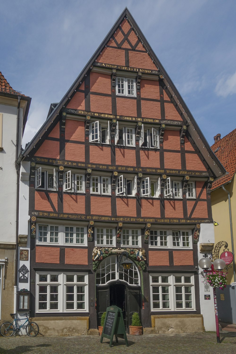 a tall building with lots of windows and a sign in front of it