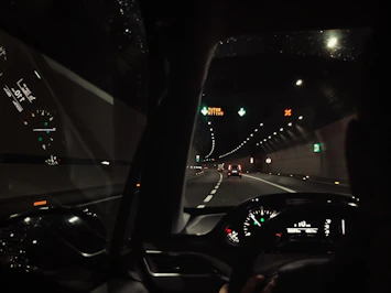 a car driving down a highway at night
