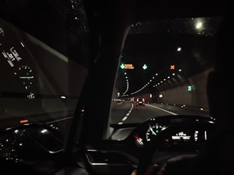a car driving down a highway at night
