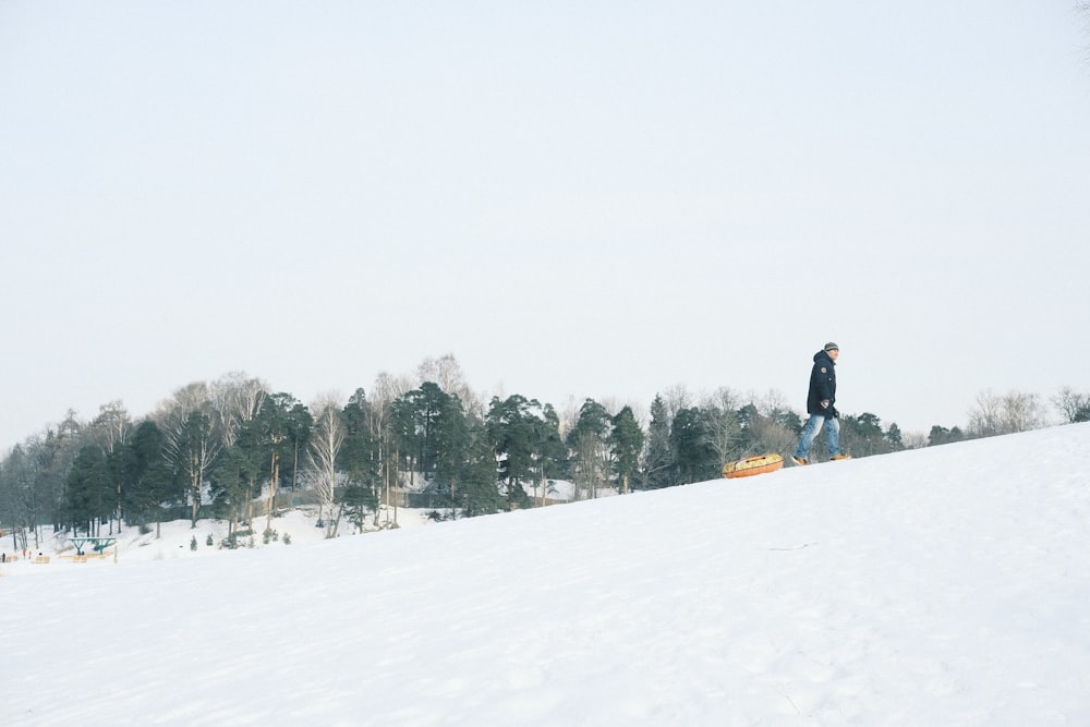 a man standing on top of a snow covered slope
