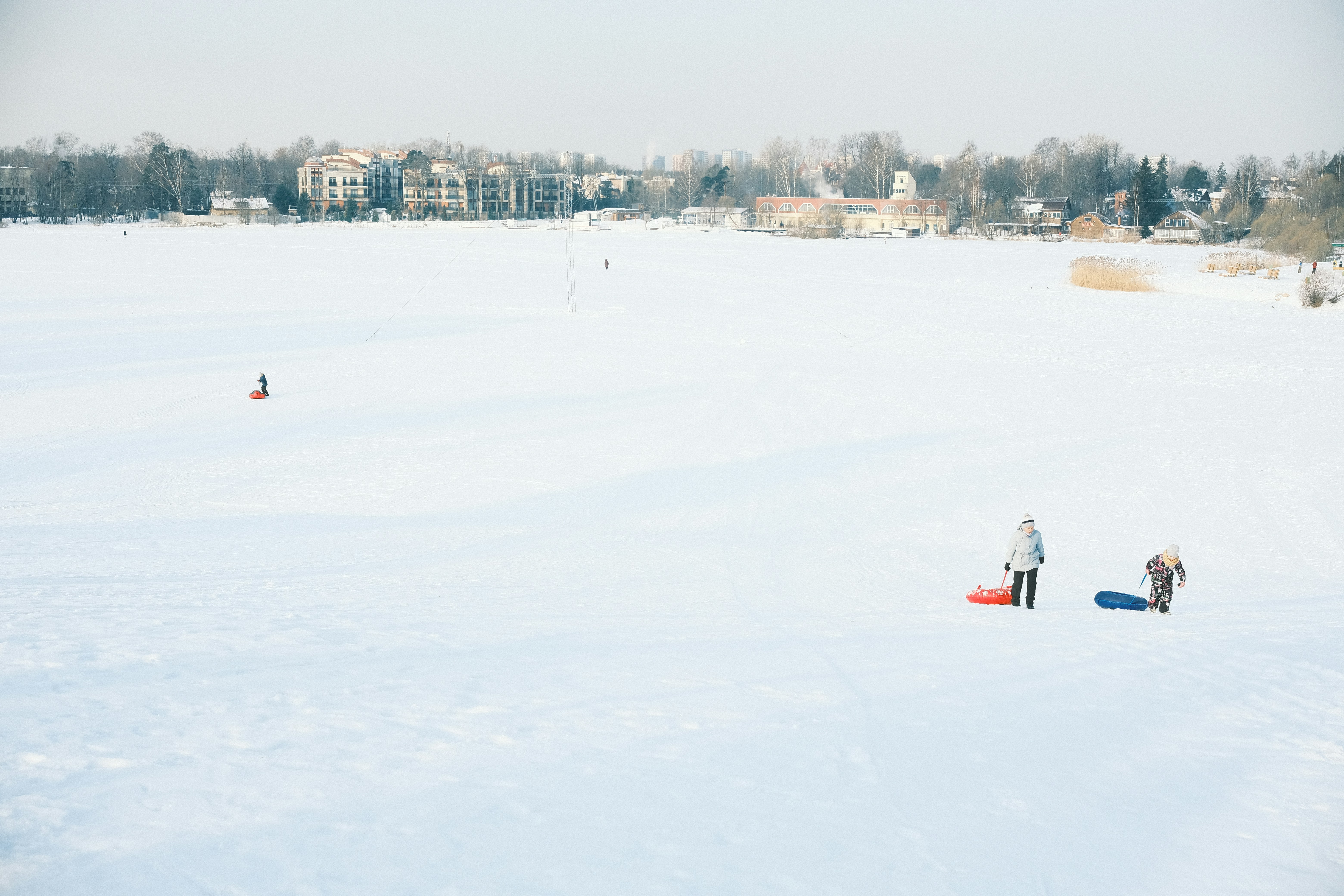 a group of people standing on top of a snow covered field