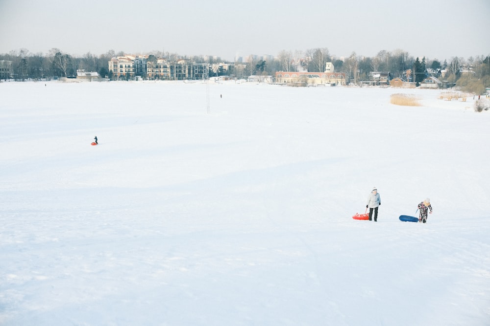 a group of people standing on top of a snow covered field