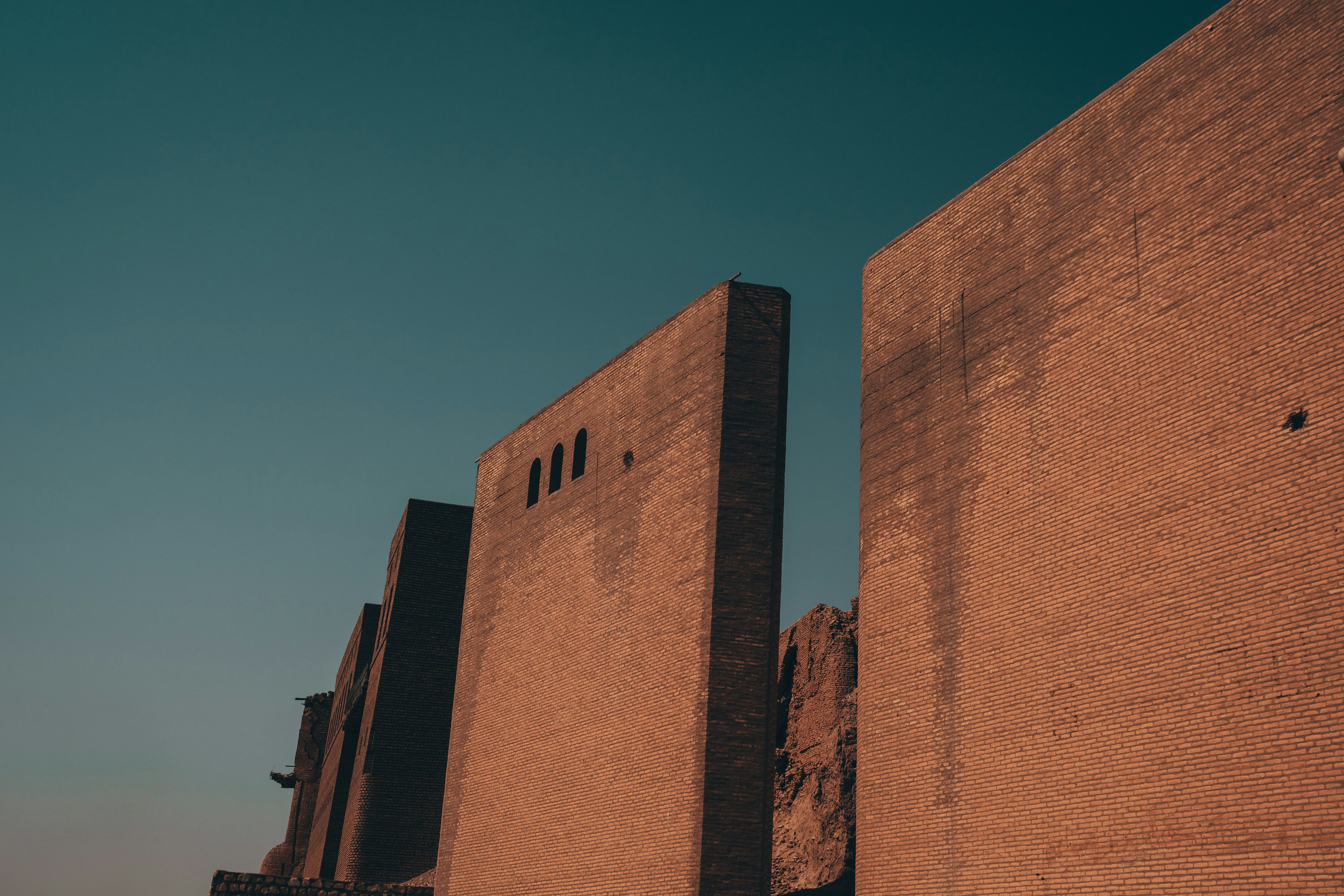 a tall brick building with a clock on the side of it, Picture of Erbil Citadel