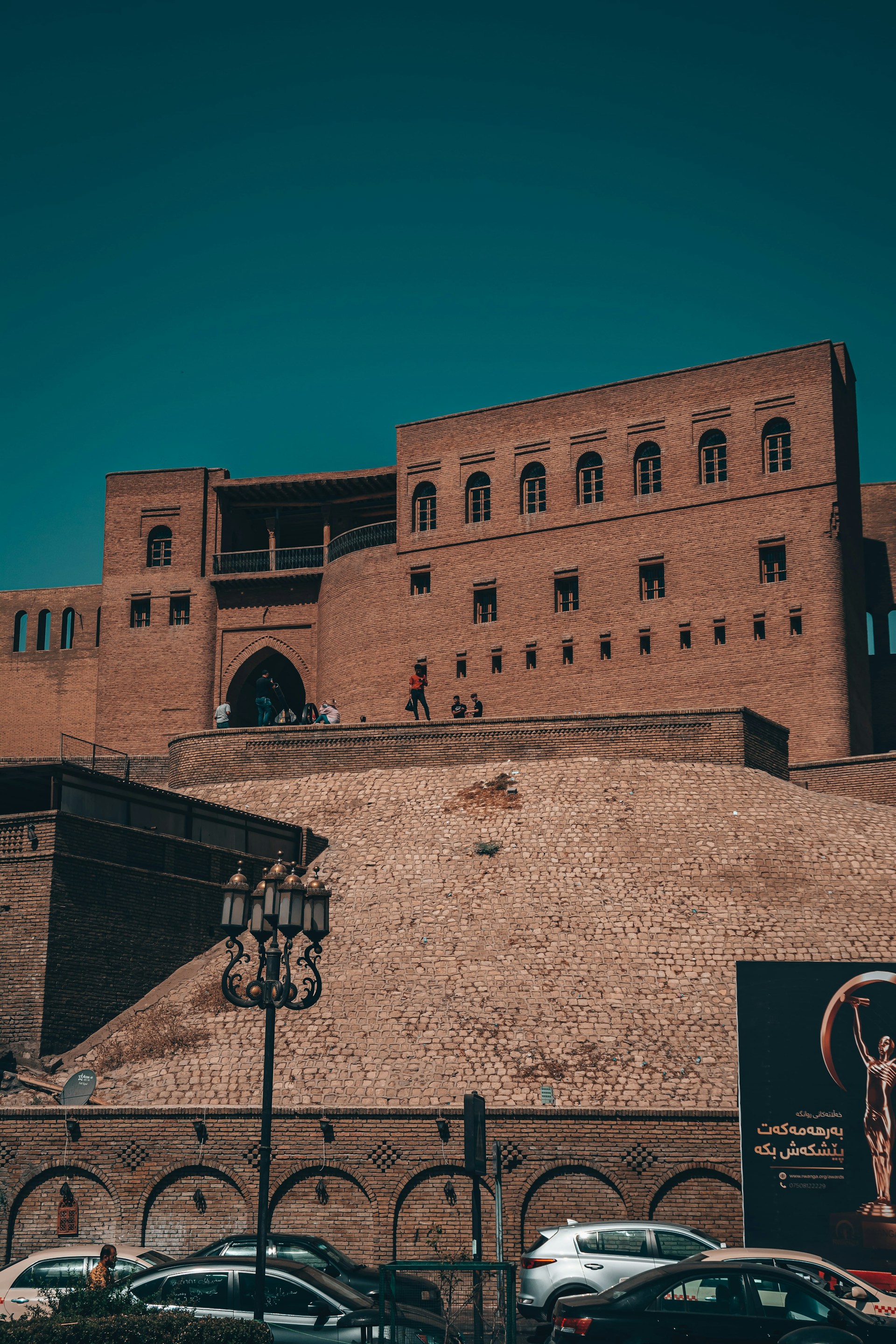 a large brick building with cars parked in front of it