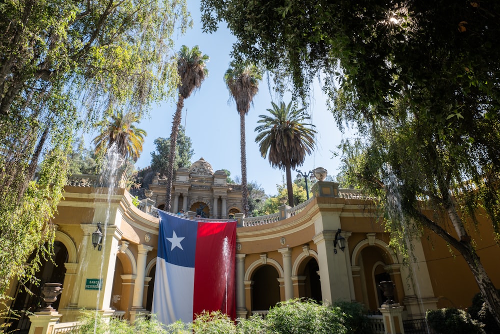 a large texas state flag hanging from the side of a building