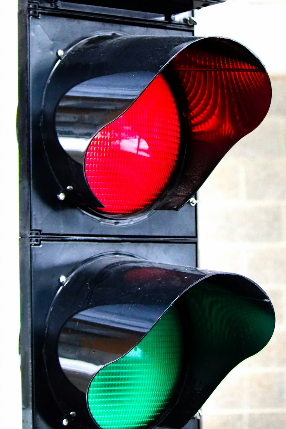 a close up of a traffic light with a red and green light