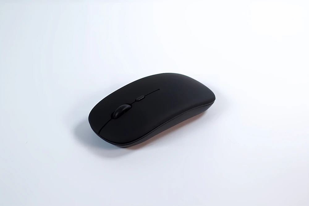 Matte black wireless mouse on white