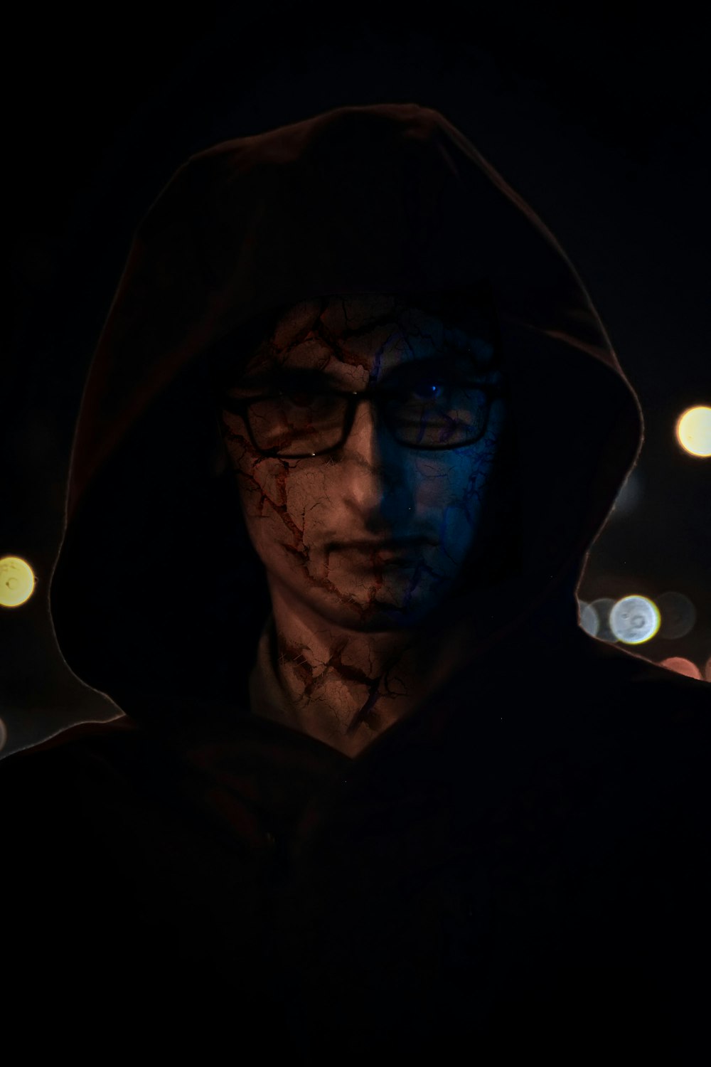 a man in a hoodie with his face painted blue