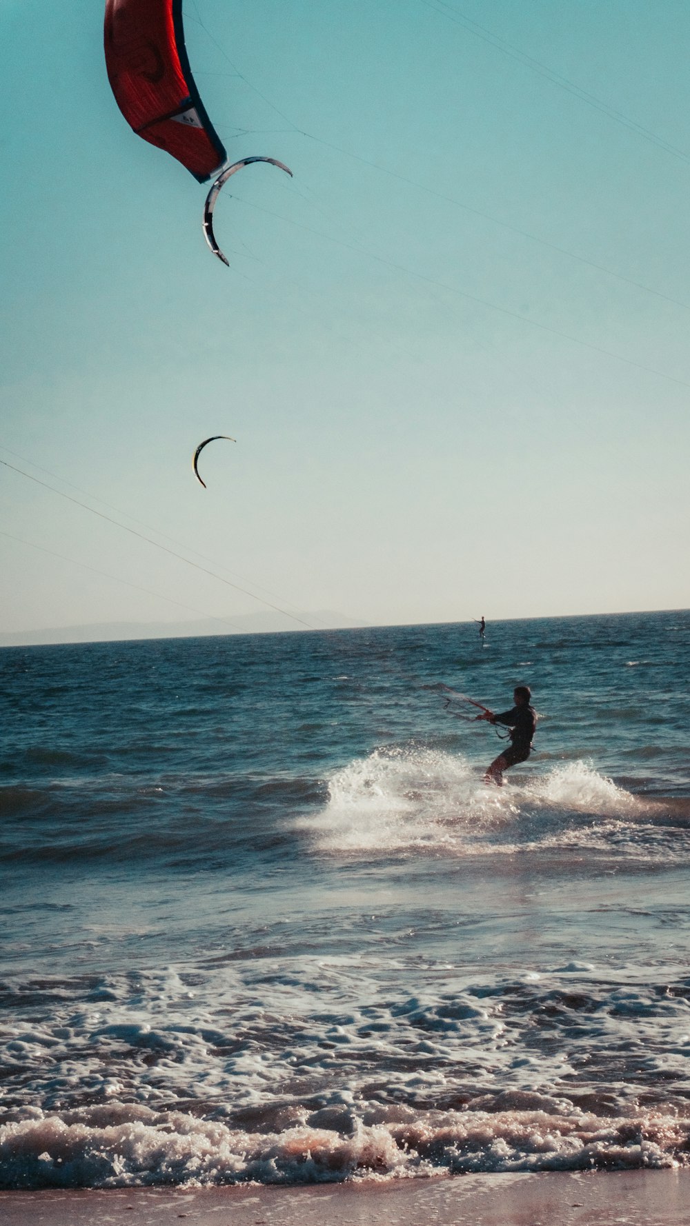 a person riding a kite board on a body of water
