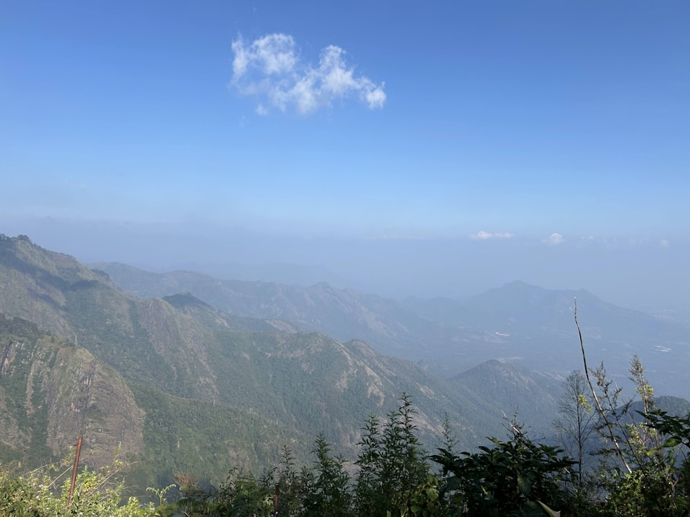 a view of a mountain range with a cloud in the sky