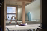 a room with a ladder and a chair in it