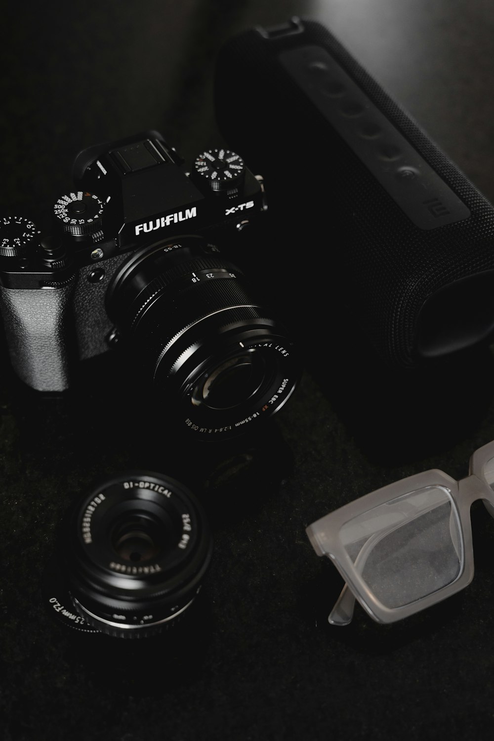 a camera and some glasses on a table