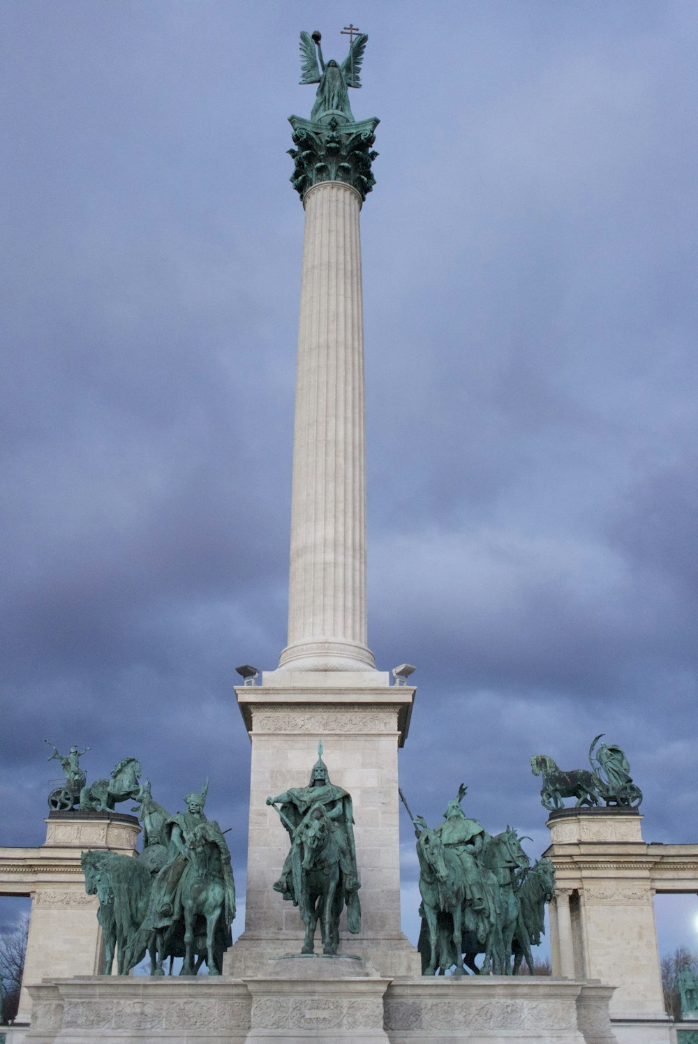 a monument with a statue of a man on top of it