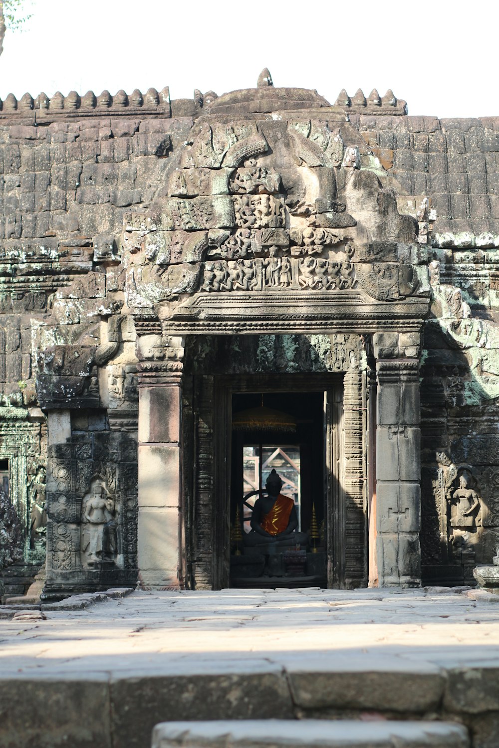 a man standing in a doorway of a stone building