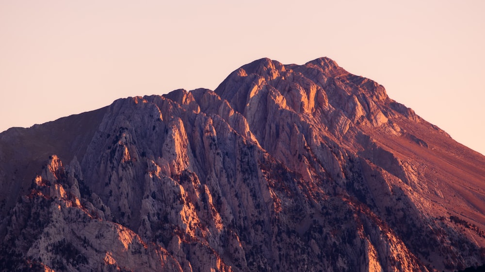 a very tall mountain with a sky in the background